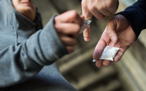 close up of addict buying dose from drug dealer