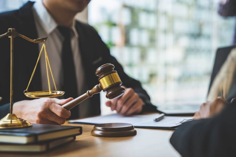 Lawyer or judge holding Hammer prepares to judge the case with justice